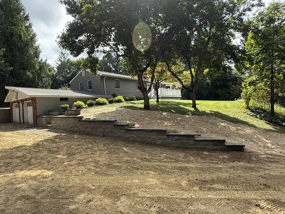 Natural stone retaining wall on a Dutchess County hillside property